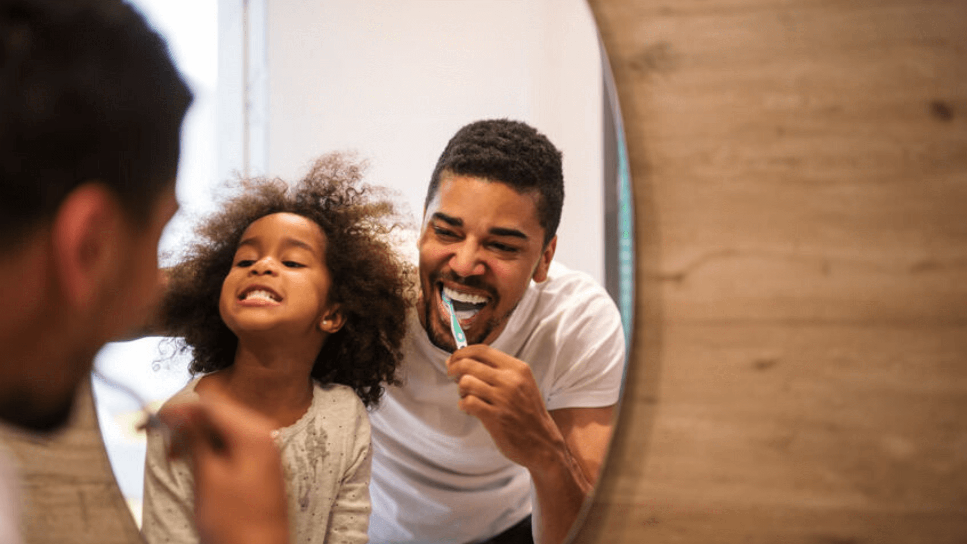 dad and daughter brushing teeth