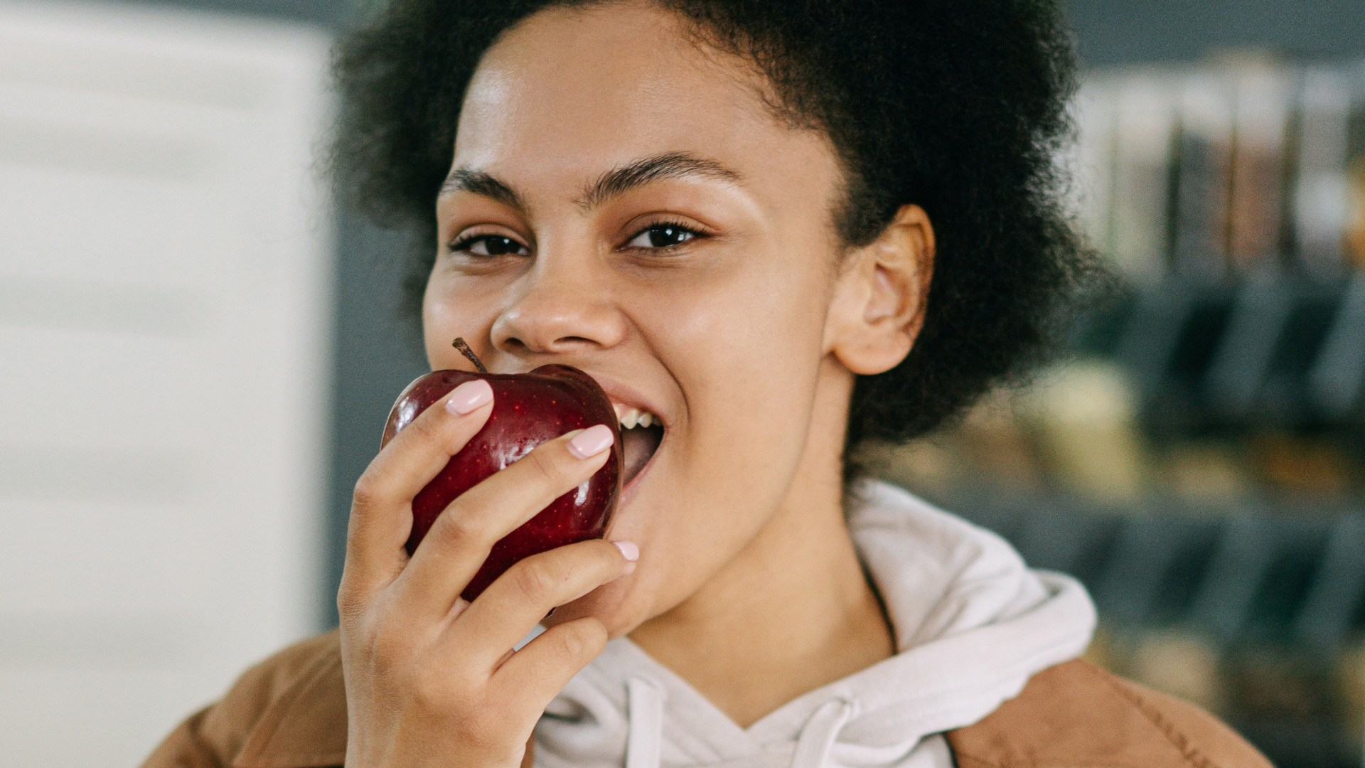 woman biting into apple